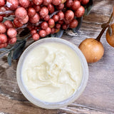 Argan and Seabuckthorn age defying creme is a natural, creamy creme in a glass jar with a sea glass and white label with botanical drawing representing sea buckthorn plants. All natural, no synthetic chemicals and pure plant based ingredients to soften, diminish the appearance of fine lines and wrinkles as well and brighten up dull, saggy, aged looking skin.