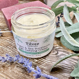 Argan and Seabuckthorn age defying creme is a natural, creamy creme in a glass jar with a sea glass and white label with botanical drawing representing sea buckthorn plants. All natural, no synthetic chemicals and pure plant based ingredients to soften, diminish the appearance of fine lines and wrinkles as well and brighten up dull, saggy, aged looking skin.